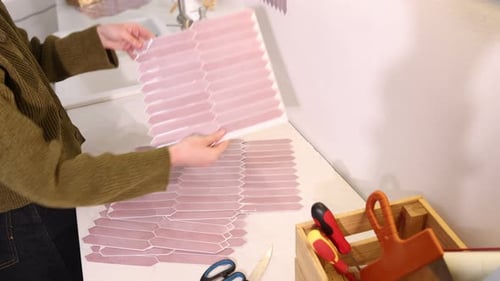 Woman Preparing Decorative Tiles in Bathroom