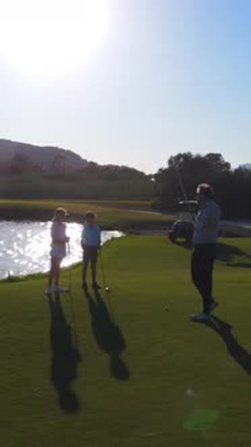 Group Golfing On Green Golf Course on Sunny Day