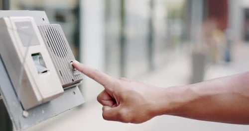 Intercom, calling and closeup of a hand on a doorbell outside an apartment or office building
