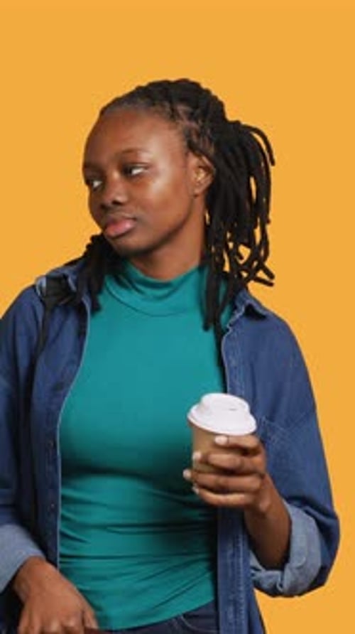 Vertical Video Tired Girl Travelling with Suitcase Drinking Coffee Studio Background
