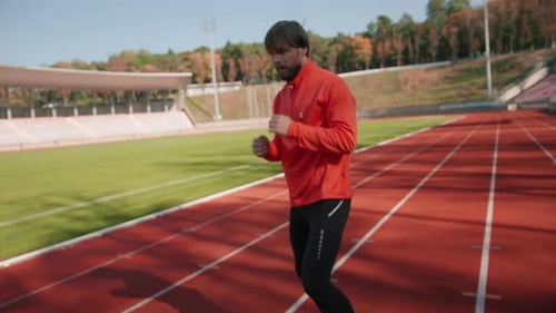 Man Warming Up and Punching on Running Track