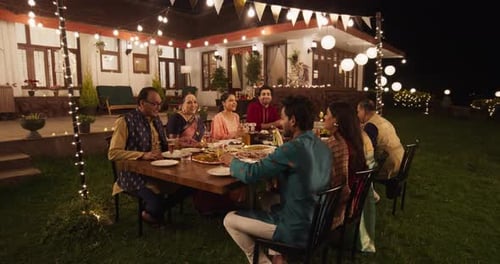 Family Gathering Celebrates with Toast at Night