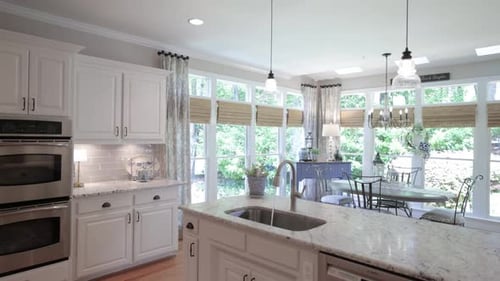 Luxury, bright kitchen in modern style large windows onto the garden. 4k footge.