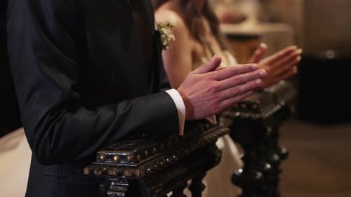 groom and bride praying together during wedding ceremony in church