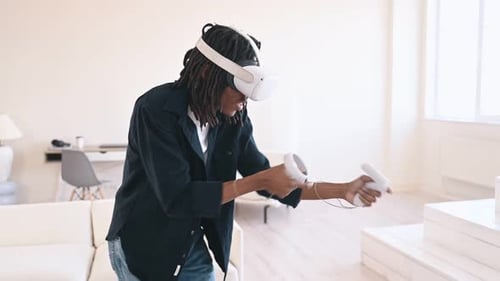 Man Using VR Headset and Controllers at Home