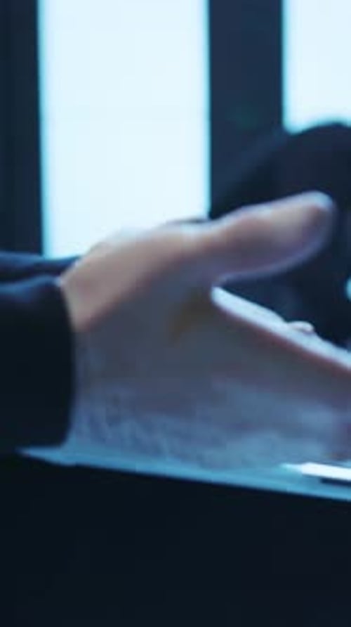 Typing with a White Mask on at Night