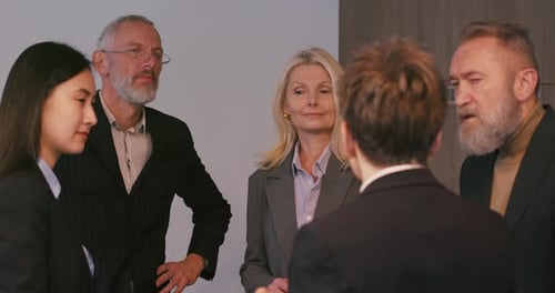 Diverse Business Professionals Communicate During Briefing