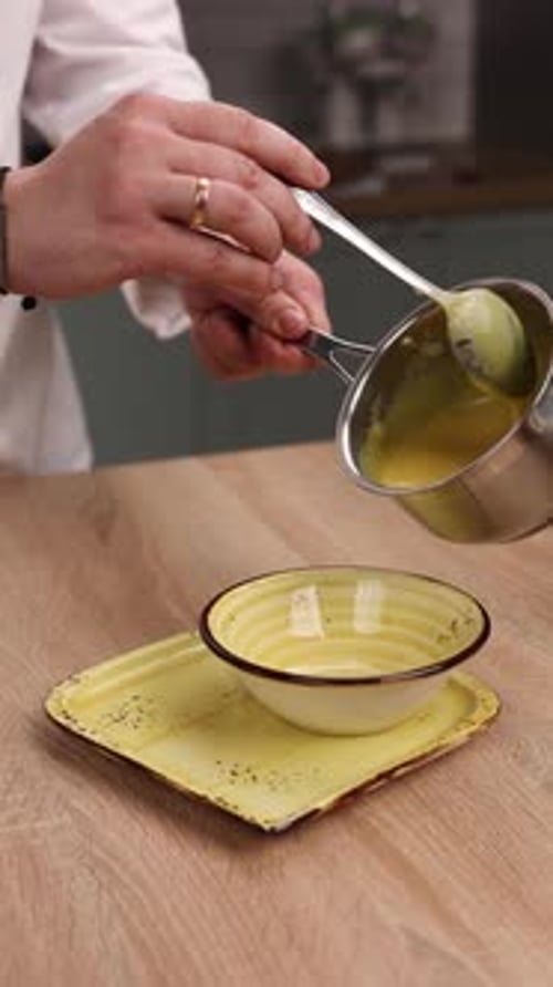 The chef is preparing a puree soup in the kitchen. Close-up