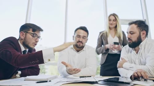 Happy Businesspeople Putting Their Hands on Top of Each Other and Laughing