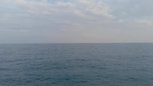 The Camera Flies Forward Low Over the Waves of the Mediterranean During the Day