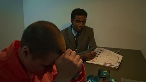 Low Key of Detective Analyzing Criminal File Talking to Female Convict