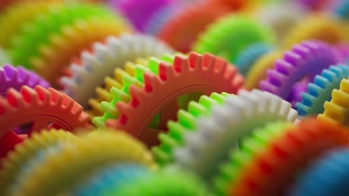 Looping 3D animation multi-colored plastic toy gears.