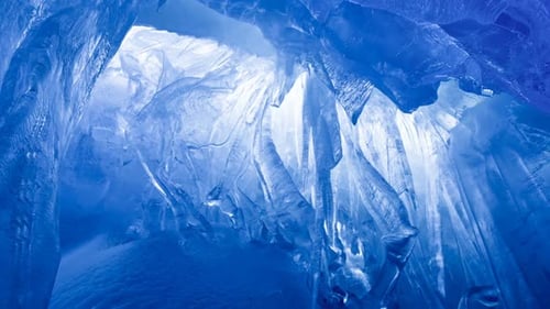 Blue Ice Cave Covered with Snow Flooded with Light