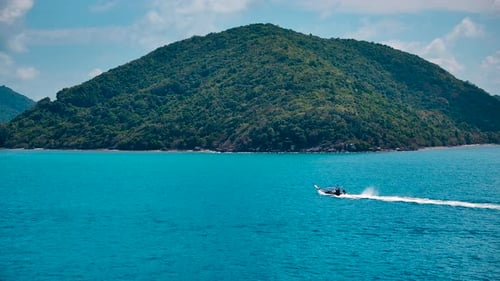 Longtail Boat Travels Across Blue Tropical Waters