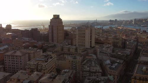 Genoa city center and business district and sea port in sunset light.