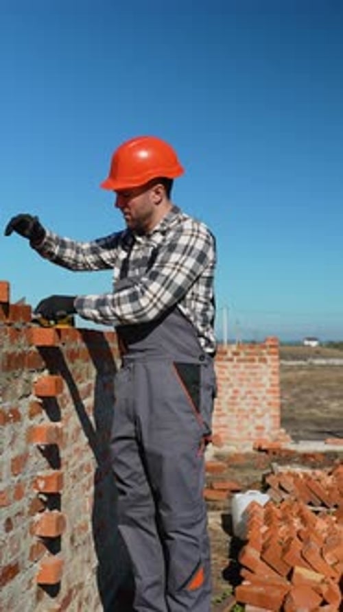 Builder Laying Bricks for Townhouse Construction