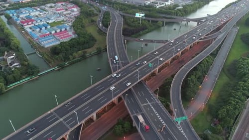 Aerial Drone View of Highway Multilevel Junction Road with Moving Cars at Sunset Active Movement of