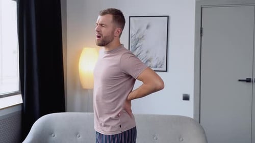 Man with Lower Back Pain in Living Room