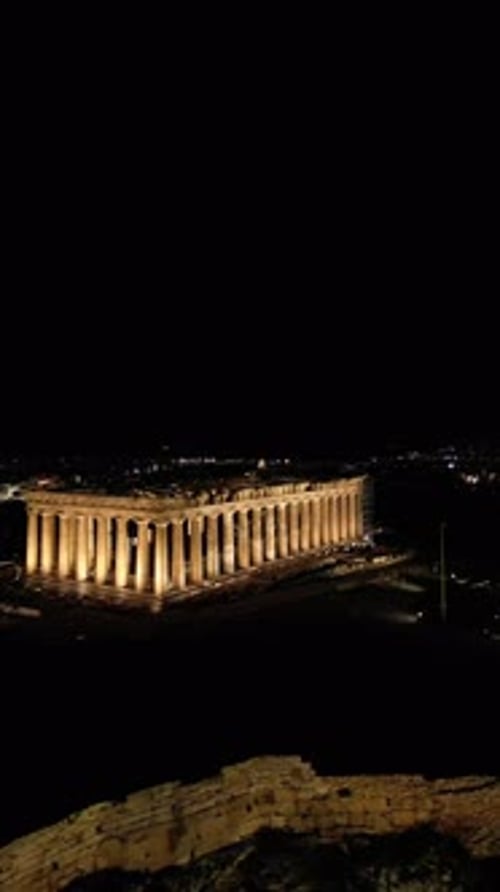 Aerial shots of the illuminated Acropolis of Athens, Greece at night