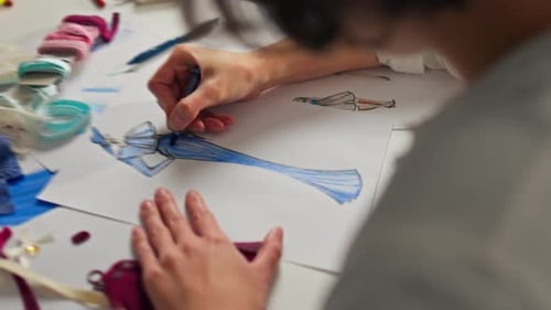 Making dress. Designer creates creative sketch of clothes. Fashion, design studio. Fashion designer