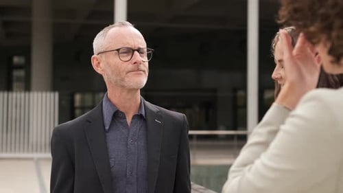 Business People Discussing Outside Office Building in City
