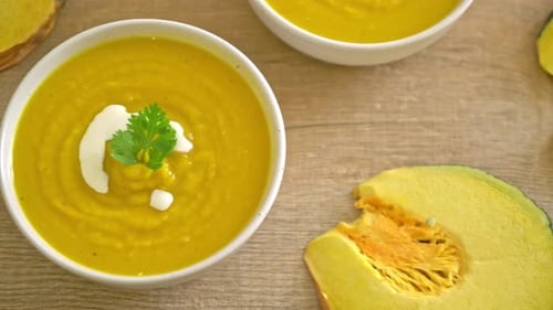 Bowl of Pumpkin Soup Garnished with Cream and Parsley