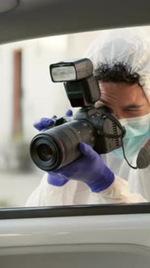 Man in Suit Taking Pictures with Camera
