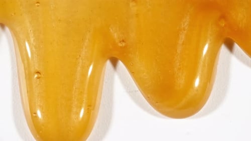 Yellow Cosmetic Gel Fluid With Molecule Bubbles Flowing On The Plain White Background Liquid Cream