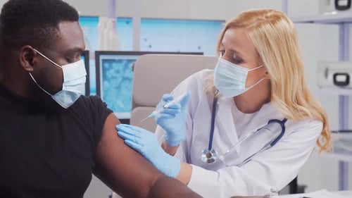 Medical Professional Giving an Injection to Patient