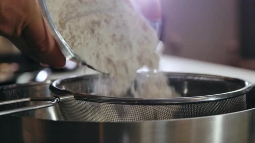 Close-Up Flour Sifting with Sieve for Bread and Pastry Making. Conception Cooking