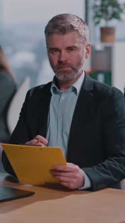 A Welldressed Man Works at His Desk Balancing Focus and Enthusiasm