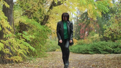 Autumn Woods Confident Woman Serene Forest Scene with Stylish Woman Walking Calm yet Introspective