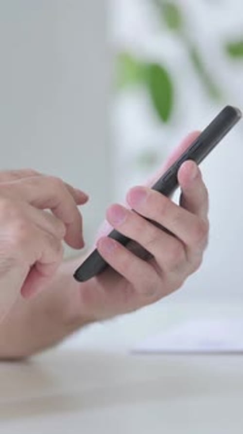 Close Up of Young Man Browsing internet on Smartphone, Vertical Video