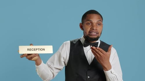 Hotel Concierge Staff Showing the Reception Indicator at Front Desk