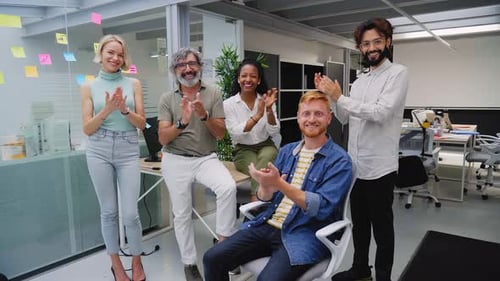 Enthusiastic Team Applauds in Modern Office