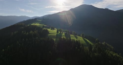 Aerial View of Sunlit Green Mountains and Hills