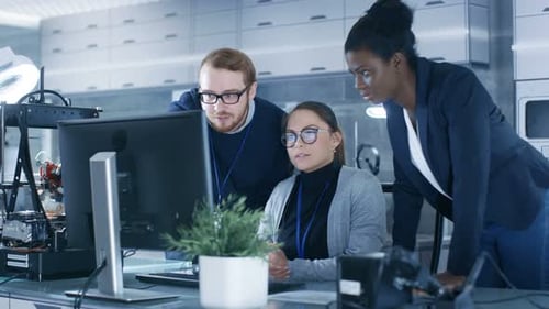 Engineering Team Collaborates in a Modern Tech Workplace