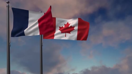 Waving Flags of France and Canada Against Blue Sky