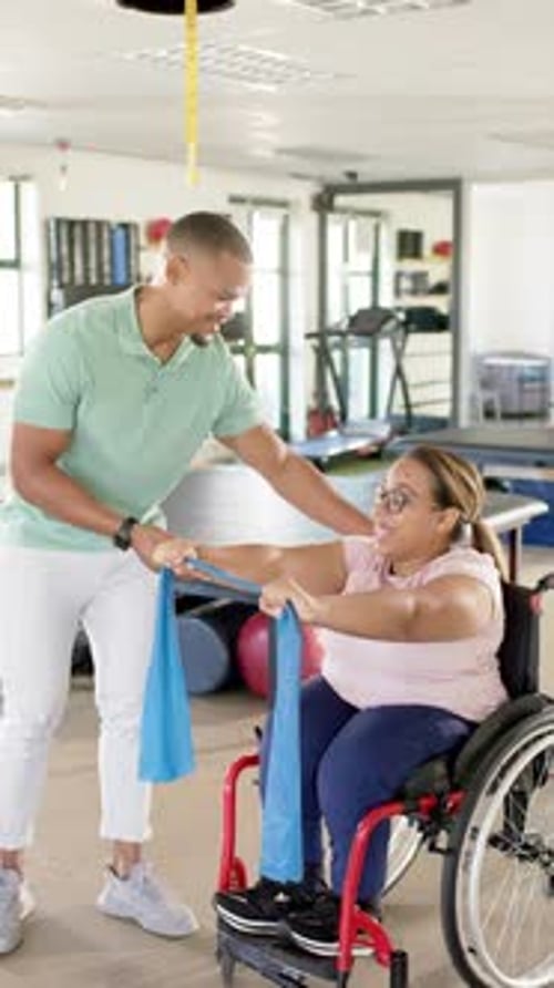 Therapist Assists Woman with Resistance Band Exercises