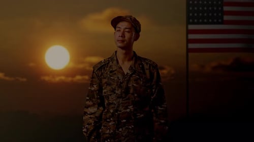 Soldier Stands Before American Flag at Sunset