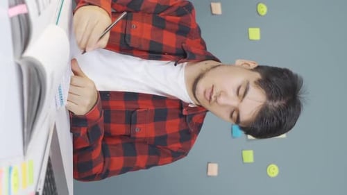 Young adult man studying at desk
