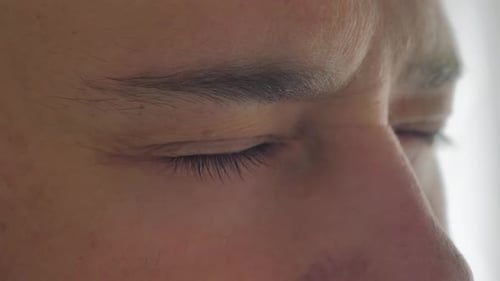 Closeup of a Man's Face Caucasian Young Man Model with Beautiful Blue Green Gray Eyes Looking