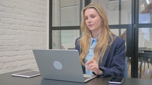 Woman in Blazer Having a Video Conference