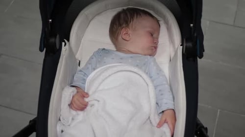Baby Sleeping Soundly in a Stroller