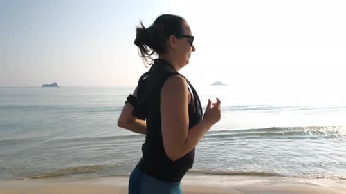 Sporty Woman Jogging on Beautiful Sandy Beach