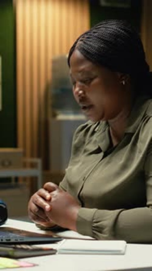 Woman on Video Call Taking Notes at Work