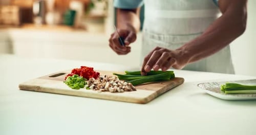 Adult Chopping Fresh Vegetables in Bright Kitchen
