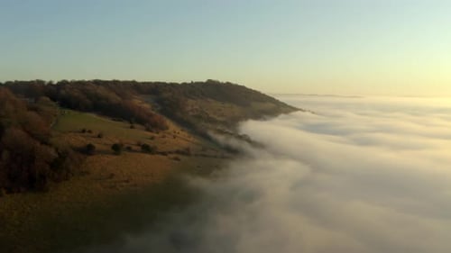 Insane drone aerial footage of beautiful cloud inversion and low clouds on a hill in the English cou