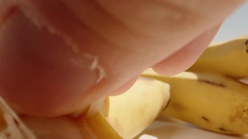 Close-Up of Peeling a Ripe Yellow Banana