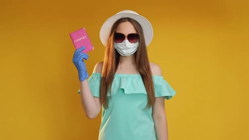 Woman with Passport Wearing Surgical Mask and Sunglasses